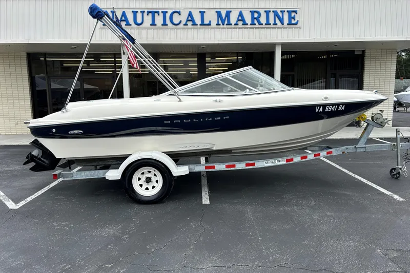 Slide: The Image of 2002 Bayliner 195 Capri boat on trailer outside Nautical Marine store. - 7