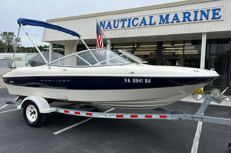 Slide: The Image of 2002 Bayliner 195 Capri boat on trailer outside Nautical Marine store. - 8