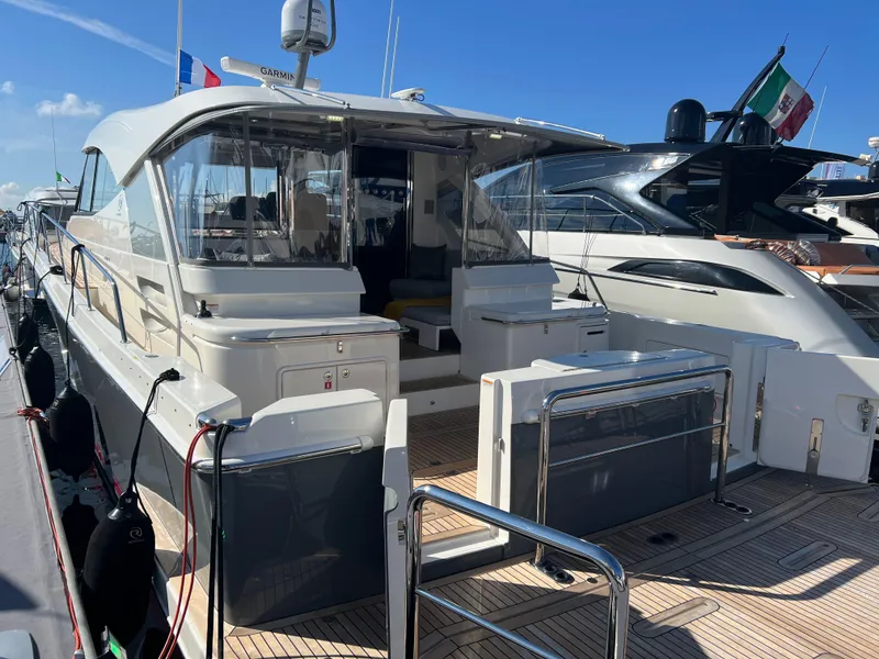 Slide: The Image of 2022 Riviera 505 SUV yacht docked at marina, showcasing sleek design and spacious deck. - 8