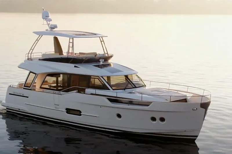 Slide: The Image of Luxurious interior of 2023 Greenline 48 Fly yacht with elegant wood finishes and panoramic windows. - 1