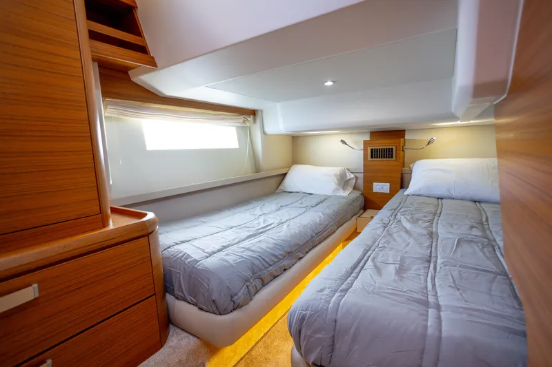 Slide: The Image of 2023 Greenline 48 Fly yacht cabin with twin beds and modern wood finish. - 13