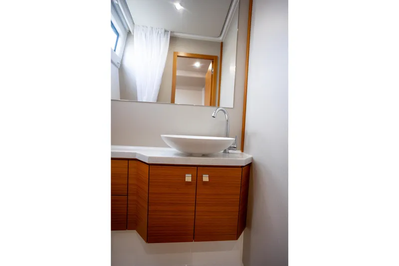 Slide: The Image of Modern bathroom interior on 2023 Greenline 48 Fly yacht, featuring sleek sink and wooden cabinetry. - 15