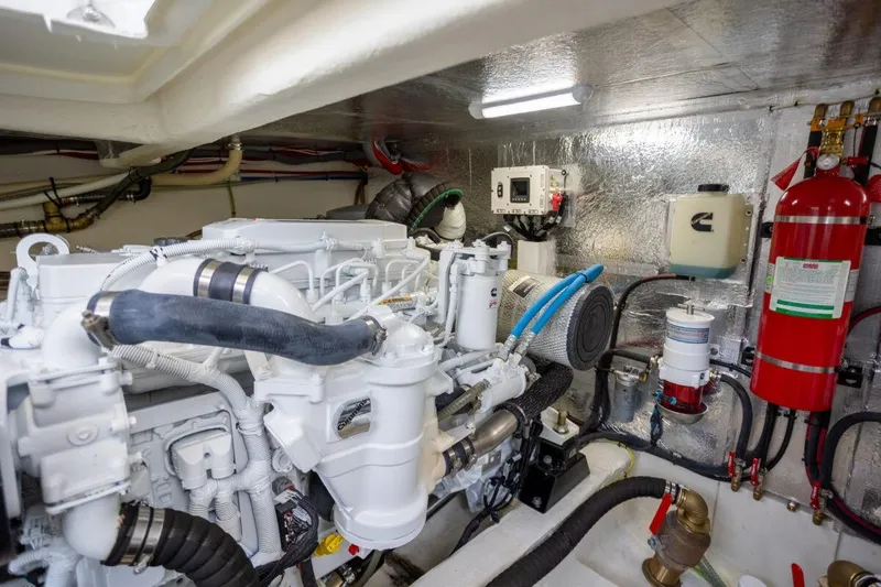 Slide: The Image of Engine room of 2023 Greenline 48 Fly yacht, featuring modern equipment and fire extinguisher. - 25