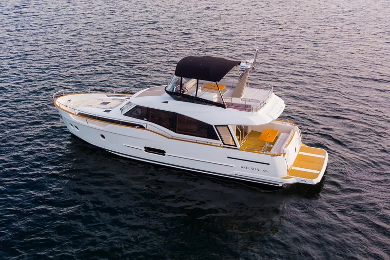Slide: The Image of 2023 Greenline 48 Fly yacht cruising on open water, featuring sleek design and spacious deck. - 29