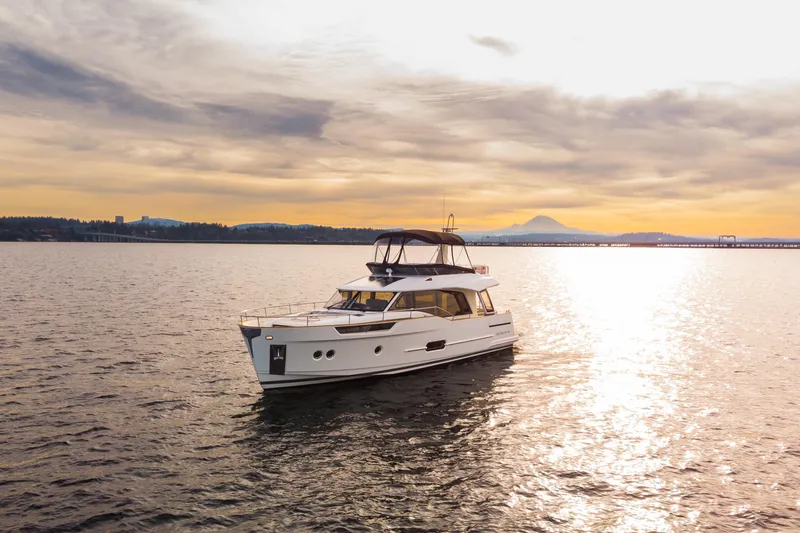 Slide: The Image of 2023 Greenline 48 Fly yacht cruising at sunset on tranquil waters. - 31