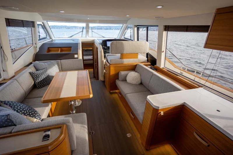 Slide: The Image of Luxurious interior of 2023 Greenline 48 Fly yacht with elegant seating and panoramic windows. - 4