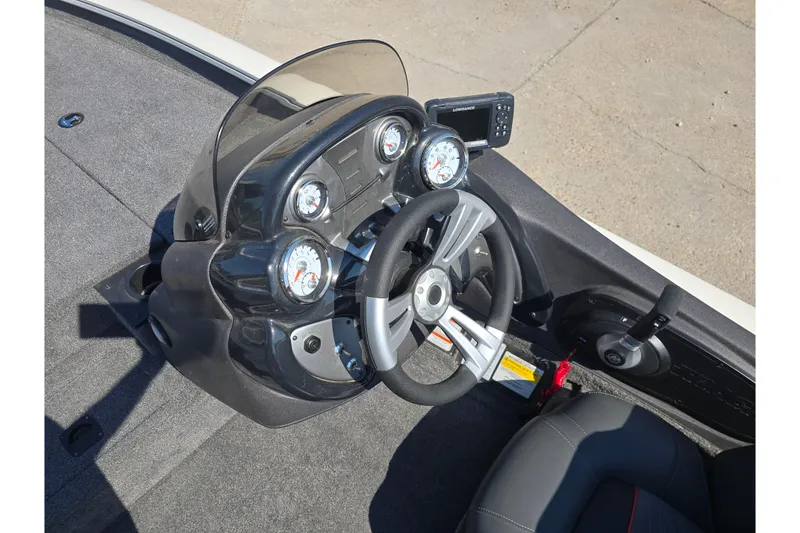 Slide: The Image of 2024 Tracker Pro Team 190 TX boat dashboard with steering wheel and gauges. - 12