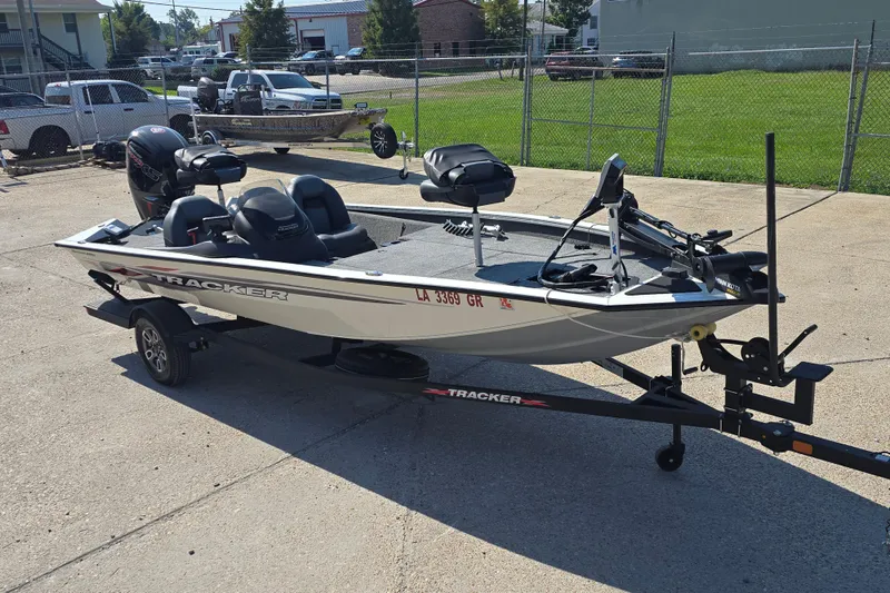 Slide: The Image of 2024 Tracker Pro Team 190 TX fishing boat on trailer in parking lot. - 2