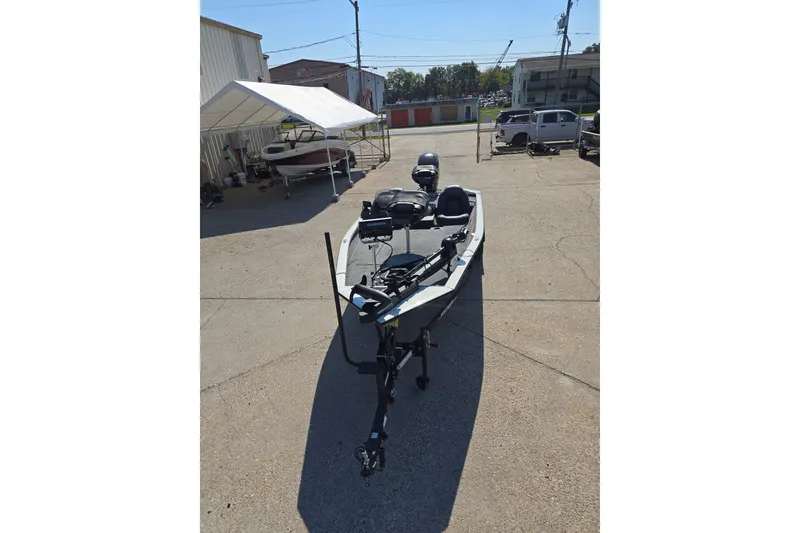 Slide: The Image of 2024 Tracker Pro Team 190 TX boat parked outdoors in a sunny lot. - 3