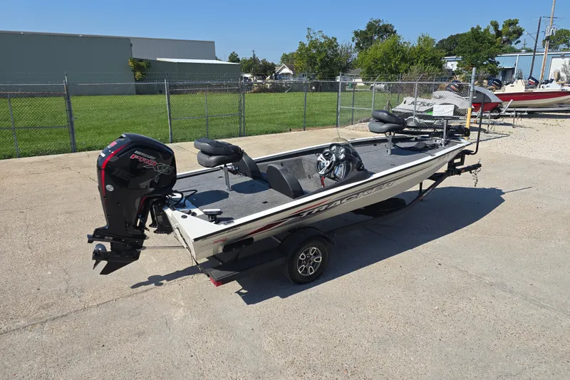 Slide: The Image of 2024 Tracker Pro Team 190 TX fishing boat on trailer, parked outdoors. - 4