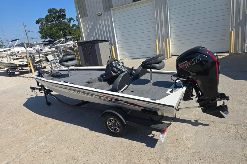 Slide: The Image of 2024 Tracker Pro Team 190 TX boat with Mercury Pro XS engine, parked outdoors. - 6