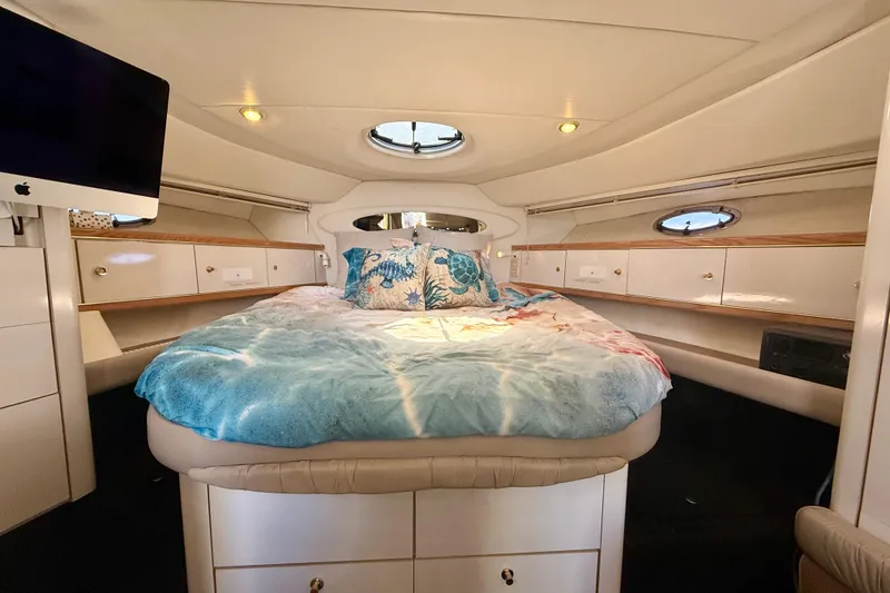 Slide: The Image of Luxurious 1997 Maxum 4100 SCR yacht cabin with cozy bed and modern decor. - 10