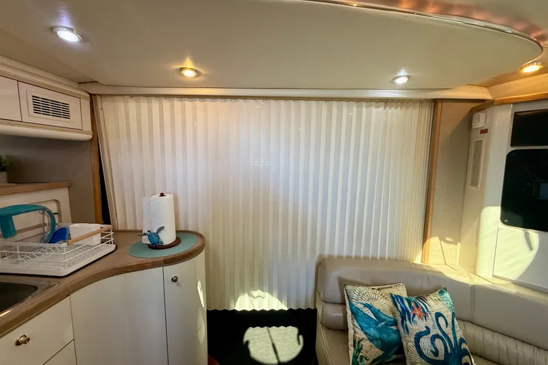 Slide: The Image of Interior of 1997 Maxum 4100 SCR yacht with cozy seating and nautical decor. - 12