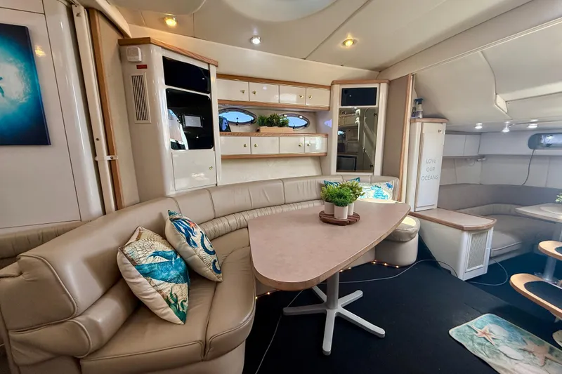 Slide: The Image of Luxurious interior of a 1997 Maxum 4100 SCR yacht with elegant seating and decor. - 13