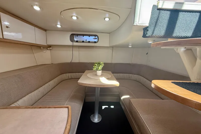 Slide: The Image of 1997 Maxum 4100 SCR yacht interior with cozy seating and table, featuring modern lighting. - 15