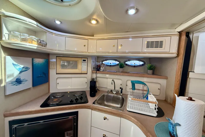 Slide: The Image of Interior of 1997 Maxum 4100 SCR yacht kitchen with stove, sink, and storage cabinets. - 19