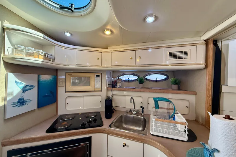 Slide: The Image of 1997 Maxum 4100 SCR yacht kitchen with microwave, stove, sink, and decor. - 20