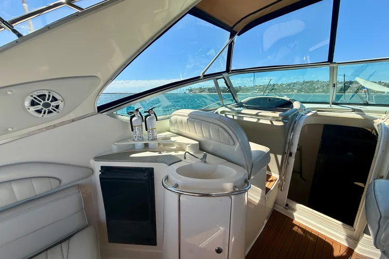 Slide: The Image of 1997 Maxum 4100 SCR yacht interior with seating, sink, and ocean view. - 23