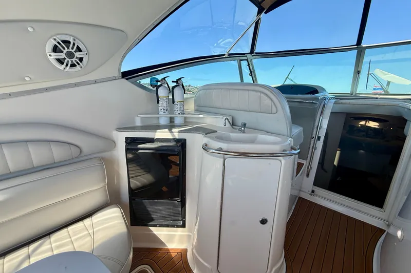 Slide: The Image of 1997 Maxum 4100 SCR yacht interior with sink, seating, and wooden flooring. - 26