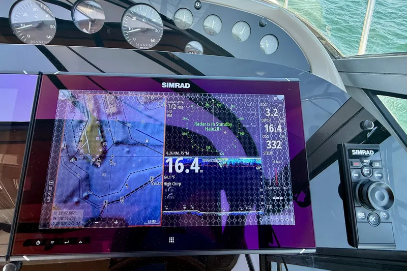 Slide: The Image of Simrad navigation system on 1997 Maxum 4100 SCR boat dashboard, displaying nautical charts. - 32