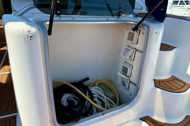 Slide: The Image of Storage compartment on a 1997 Maxum 4100 SCR boat with ropes and cables. - 36