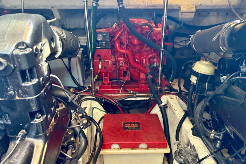 Slide: The Image of Engine compartment of a 1997 Maxum 4100 SCR boat, featuring red and black components. - 42