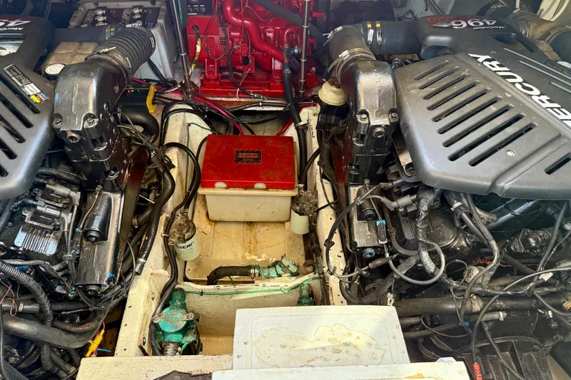 Slide: The Image of Engine compartment of a 1997 Maxum 4100 SCR boat, featuring dual Mercury engines. - 46