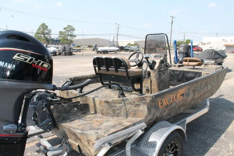 Slide: The Image of 2026 Excel 1854 F4 Shallow Water boat with Yamaha SHO engine, parked on a trailer. - 7