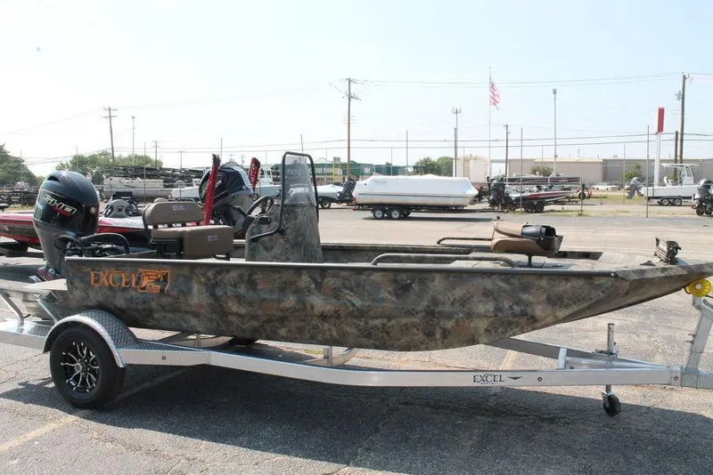 Slide: The Image of 2026 Excel 1854 F4 Shallow Water boat on trailer, parked in a lot. - 6