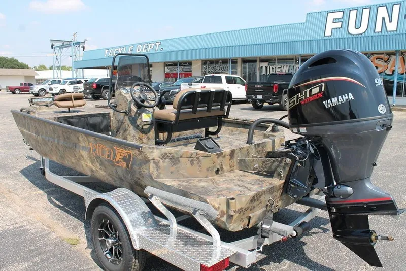 Slide: The Image of 2026 Excel 1854 F4 Shallow Water boat with Yamaha engine on trailer, parked outside store. - 9