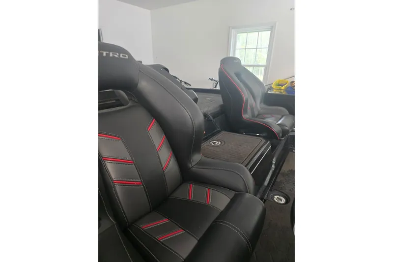 Slide: The Image of 2023 Nitro Z21 XL Pro boat seats with black and red stitching in a well-lit interior. - 3
