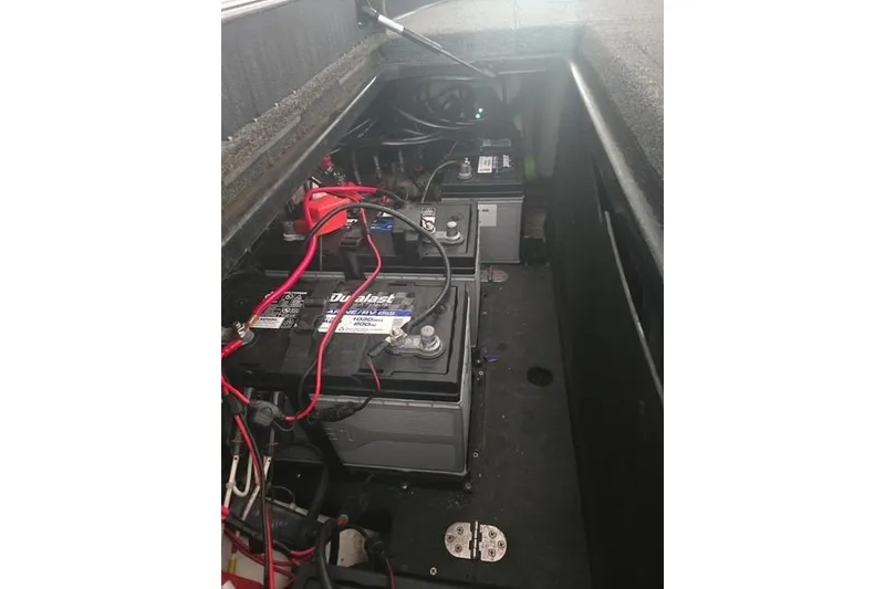 Slide: The Image of 2023 Nitro Z21 XL Pro boat battery compartment with multiple batteries and wiring. - 6