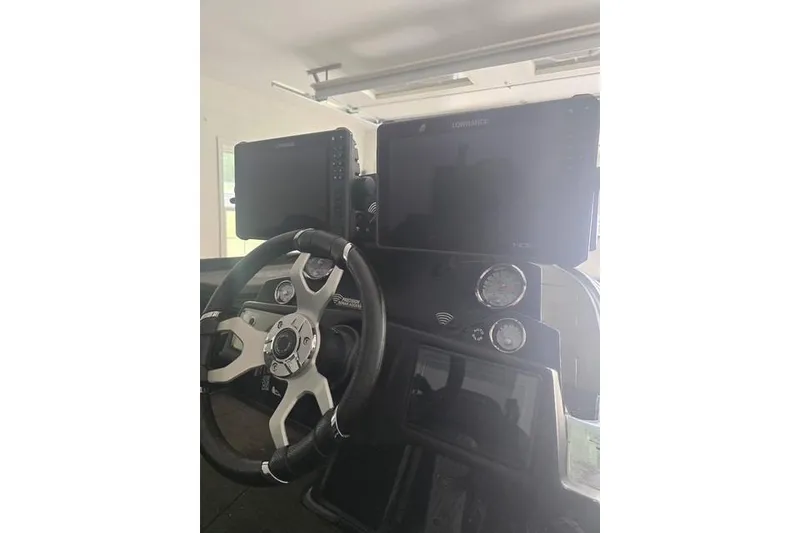 Slide: The Image of 2023 Nitro Z21 XL Pro boat dashboard with steering wheel and electronic displays. - 9