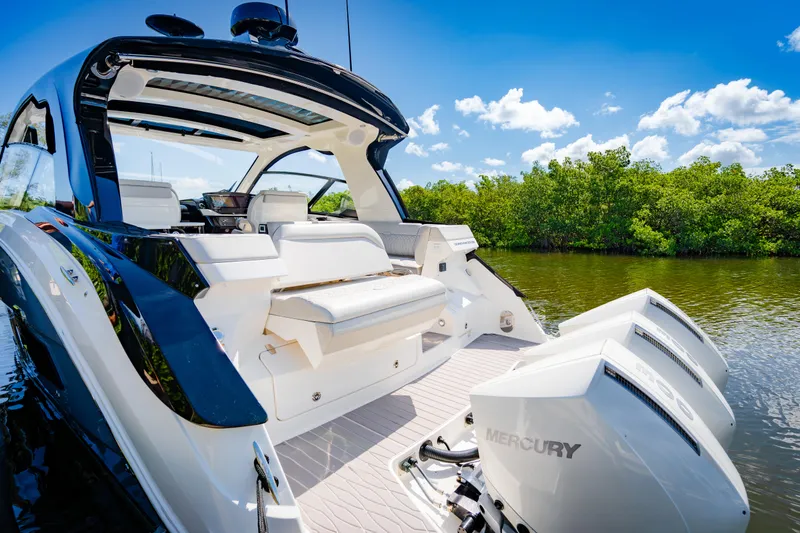 Slide: The Image of 2023 Sea Ray Sundancer 370 OB with triple Mercury outboard engines on a sunny day. - 12