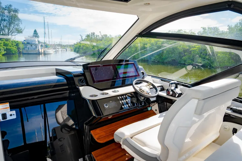 Slide: The Image of 2023 Sea Ray Sundancer 370 OB helm with advanced navigation system and luxurious seating. - 21