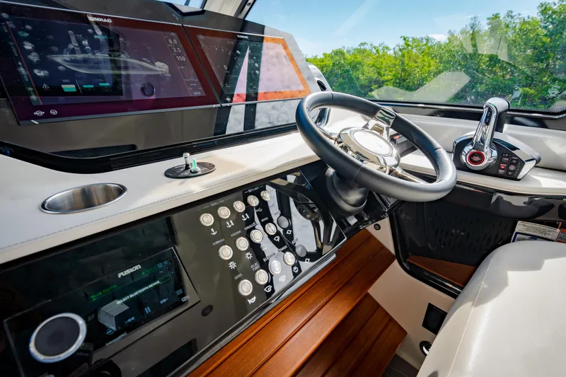 Slide: The Image of 2023 Sea Ray Sundancer 370 OB helm with modern controls and touchscreen displays. - 23