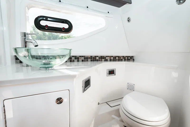Slide: The Image of Modern bathroom in 2023 Sea Ray Sundancer 370 OB yacht with glass sink and mosaic backsplash. - 36