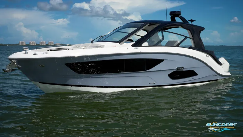 Slide: The Image of 2023 Sea Ray Sundancer 370 OB boat on water under blue sky. - 4