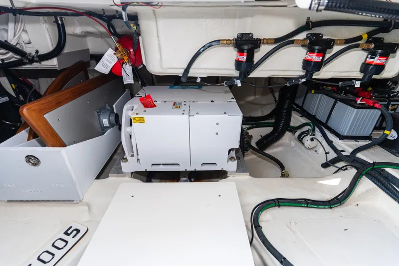 Slide: The Image of Engine compartment of 2023 Sea Ray Sundancer 370 OB with generator and wiring. - 41