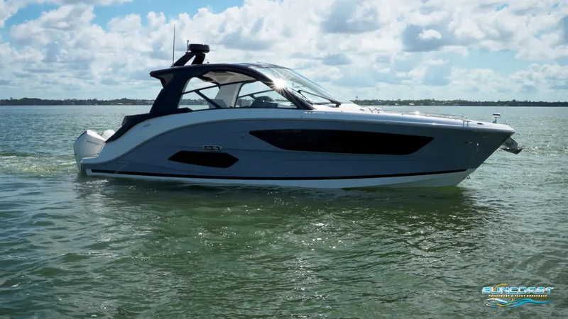 Slide: The Image of 2023 Sea Ray Sundancer 370 OB cruising on calm waters under a partly cloudy sky. - 45