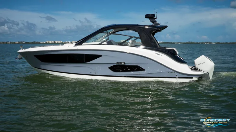 Slide: The Image of 2023 Sea Ray Sundancer 370 OB cruising on open water under a clear sky. - 5