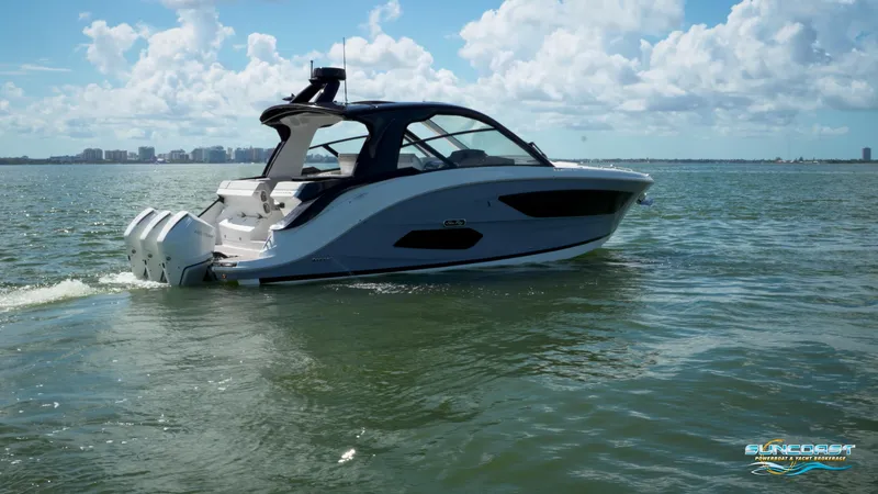 Slide: The Image of 2023 Sea Ray Sundancer 370 OB cruising on calm waters under a partly cloudy sky. - 8
