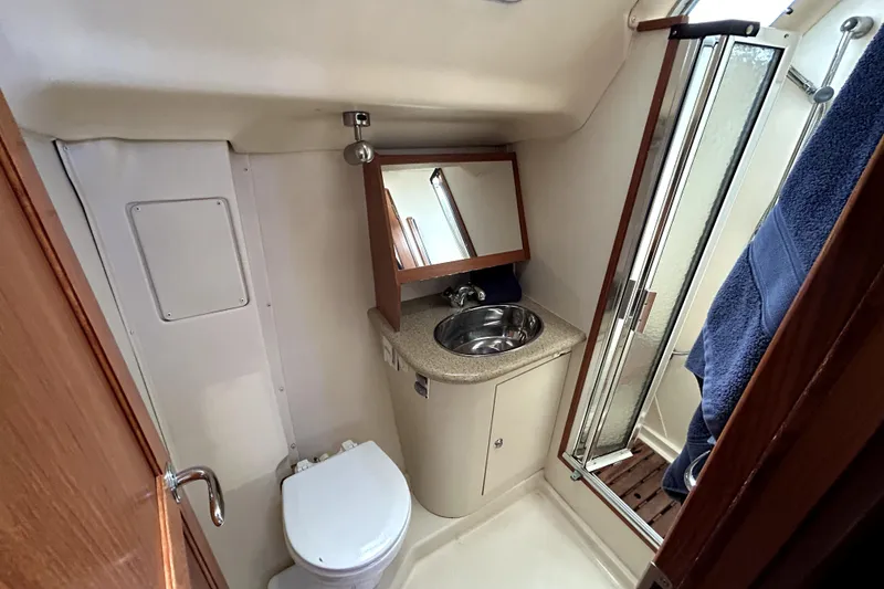 Slide: The Image of Interior of 2007 Hunter 41 Deck Salon with cozy seating and wooden finishes. - 15