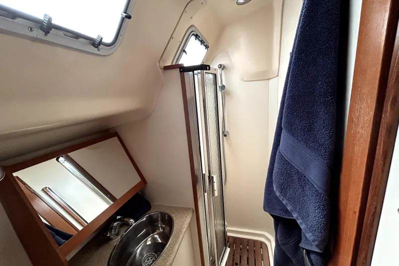 Slide: The Image of Interior of 2007 Hunter 41 Deck Salon yacht with wood finish and cozy seating area. - 16