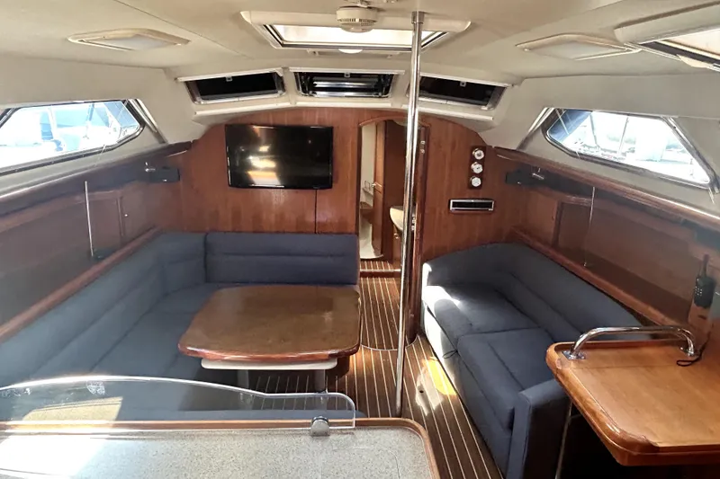 Slide: The Image of 2007 Hunter 41 Deck Salon sailboat docked in marina under clear blue sky. - 2