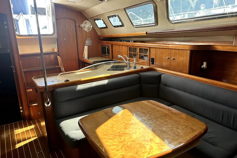 Slide: The Image of 2007 Hunter 41 Deck Salon kitchen with stove, microwave, and dual sink. - 21