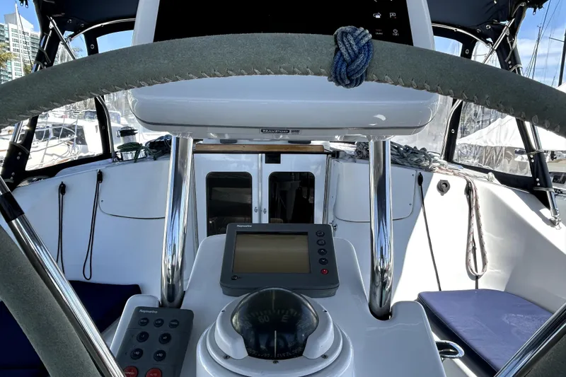 Slide: The Image of Cockpit of 2007 Hunter 41 Deck Salon sailboat with navigation equipment and cup holders. - 27