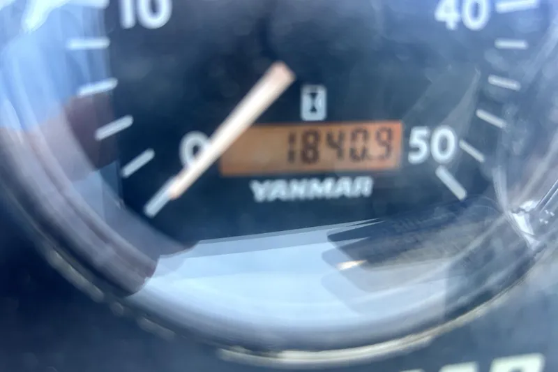 Slide: The Image of Mast of 2007 Hunter 41 Deck Salon sailboat in marina under clear blue sky. - 32