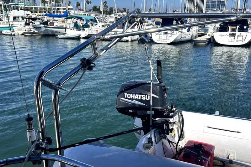 Slide: The Image of 2007 Hunter 41 Deck Salon with Tohatsu outboard motor in marina setting. - 39