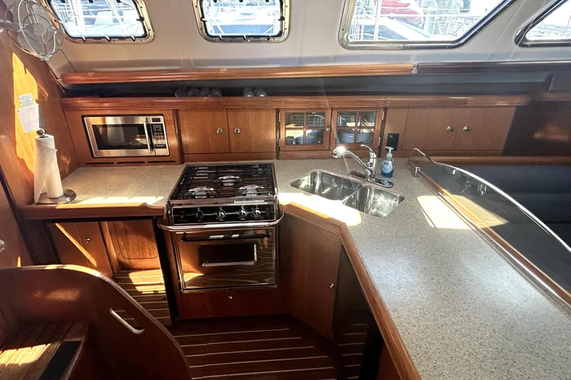 Slide: The Image of Sailing yacht Hunter 41 Deck Salon 2007 on open water with mountains in background. - 6